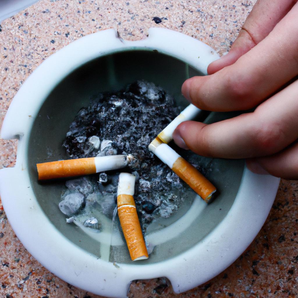 Person extinguishing cigarette in ashtray